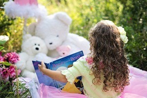 Matthew Effect - photo of child reading to teddies